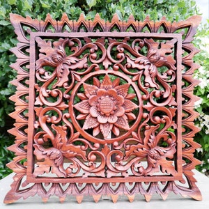 Carved wooden mandala wall sculpture with ornate square floral medallion, reddish-brown wood