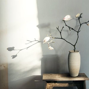 Tall ribbed ceramic flower vase in light cream, smooth rounded body