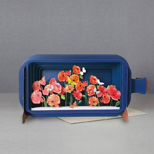 Blue pop-up greeting card with 3D orange and pink flowers and white details