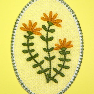 Oval machine embroidery design with cameo flowers and leaves, multicolor thread