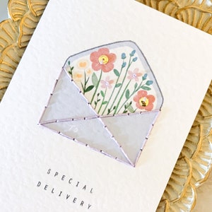Handmade embroidered greeting card with flower bouquet in envelope, special delivery text