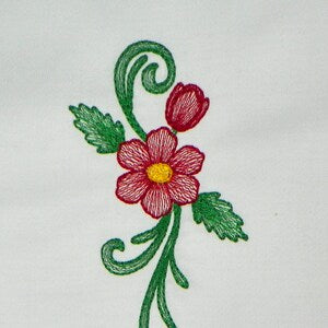 Floral embroidery design with red and pink flower, green leaves on white fabric