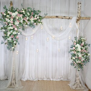 Wedding archway corner flower swag with dusty pink and white blooms, with draped white fabric