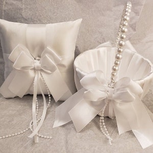 White ring bearer pillow set with satin bows and pearl beaded trim