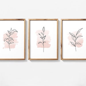 Set of three framed botanical line art prints with pastel pink watercolor flowers and leaves