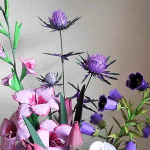 Paper flower bouquet with purple thistle-style blooms and pink blossoms on stems