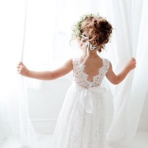 White lace flower girl dress with sleeveless bodice and layered tulle skirt