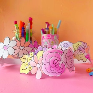 Printable flower crown craft paper with outlined pink, yellow, and white blossoms