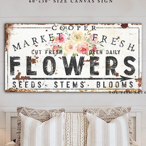 Vintage farmhouse canvas wall sign reading FLOWERS with distressed typography and floral accents