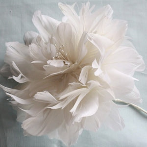 White feather flower centerpiece with layered feather petals