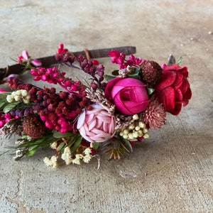 Pink peony flower headband with dark berry blossoms and greenery