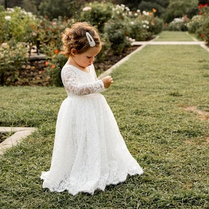 White lace girl's dress with long sleeves and A-line skirt