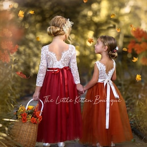 Long-sleeve flower girl dress with white lace bodice and red tulle skirt, bow details