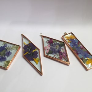 Set of 4 triangular flower sun catchers with stained-glass style panels and gold frames