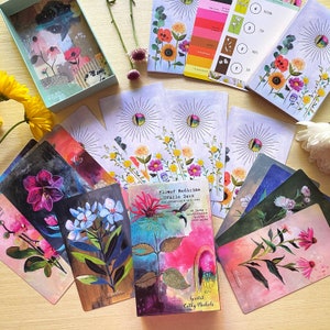 Floral oracle deck cards with colorful flower illustrations, presented as a gift set