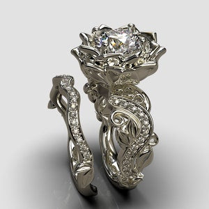 Silver diamond flower ring set with raised floral crowns and sparkling stones