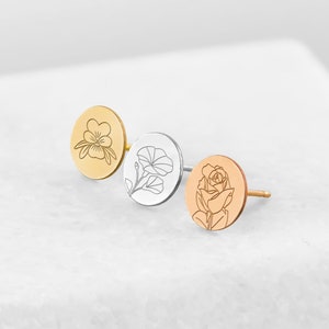 Birth flower stud earrings set in gold, silver, and rose-gold tones with engraved blooms.