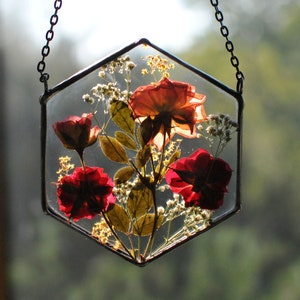Hexagon stained glass style hanging frame with red pressed flowers and white blossoms