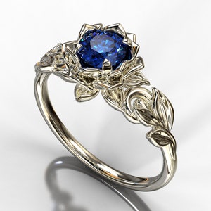 Blue sapphire leaf engagement ring with round blue gemstone in ornate silver setting
