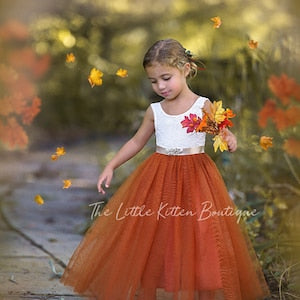 Burnt orange tulle flower girl dress with white lace bodice and fabric flowers on bodice