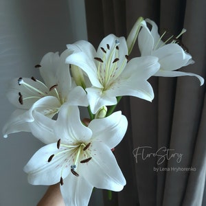 White lily flower arrangement with green buds and dark stamens for a vase