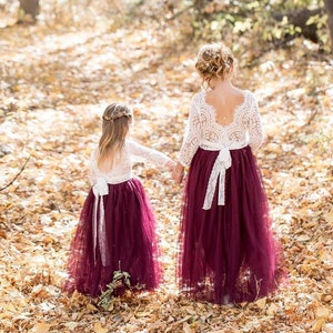 Burgundy tulle flower girl dress with white lace bodice and long sleeves, floor length