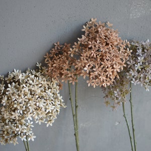 Artificial wildflower stems with small clustered blooms in beige-brown, gray, and off-white