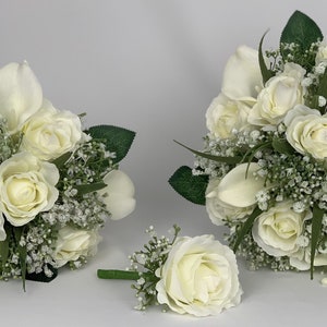 Ivory artificial wedding bouquet set with roses, gypsophila filler, and green leaves