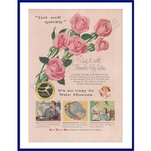 Framed vintage advertisement print with pink roses and small illustrated text blocks.