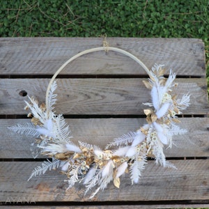 White dried flower decorative wreath with pinecone and botanical accents
