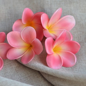 Coral pink artificial plumeria flower heads with soft gradient petals