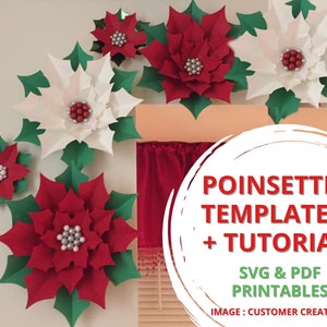 Red poinsettia and green leaf paper flower decoration with small berry accents