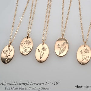 Gold-tone oval birth flower pendant necklace with delicate line-art blooms and chain