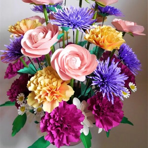 Paper flower bouquet with pink roses, purple and yellow blooms, and green leaves