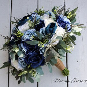 Bridal bouquet with navy and dusty blue silk roses, ivory flowers, and green leaves, tied handle