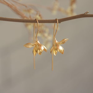 Gold flower drop earrings with hook backs and dangling petals