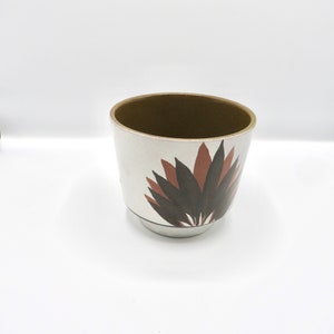 Ceramic flower pot planter with white base and red leaf pattern