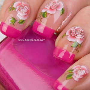 Floral rose nail art water transfer stickers on pink nails, three accent designs