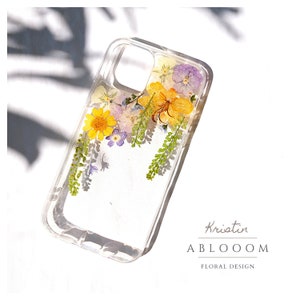 Clear pressed flower phone case with purple and yellow blooms, slim protective back cover