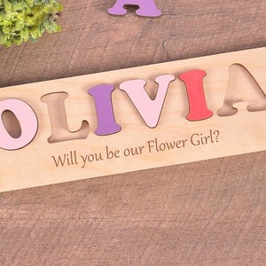 Wooden flower girl name puzzle with the text “Will you be our Flower Girl?”
