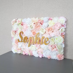 Floral nursery name sign with pink and white roses and script text 'Sephie'