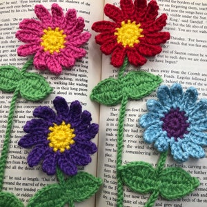 Set of crochet flower bookmarks with yellow centers and green leaves