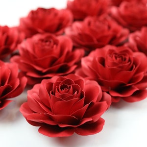 Red layered paper rose flowers, small-to-medium size set on display