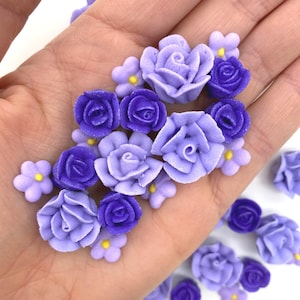 Edible royal icing flowers in light and dark purple, small blossom cake toppers