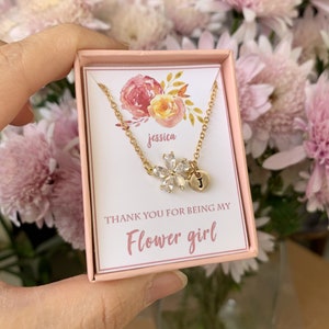 Gold-tone flower girl necklace with heart and floral charms in a gift box