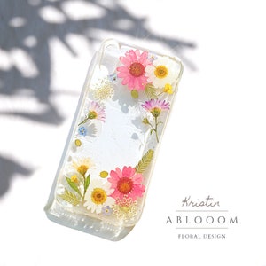 Pressed flower phone case with clear background and colorful blossoms, slim protective cover