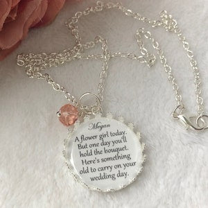 Silver chain necklace with round engraved pendant and small pink charm