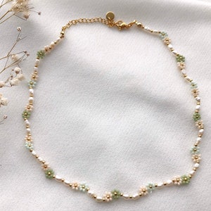 Handmade freshwater pearl flower necklace with small gold clasp and pastel green accents