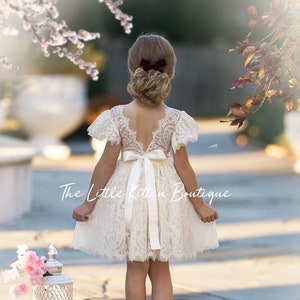 White lace flower girl dress with short sleeves and back bow