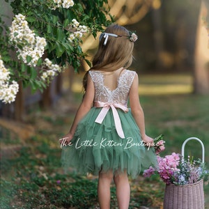 Girls lace bodice flower girl dress with blush top and green tulle skirt, back view.
